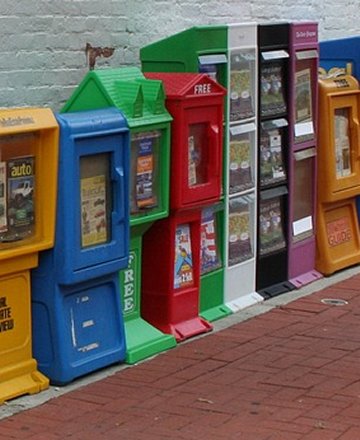 A picture of vending machines on a street.